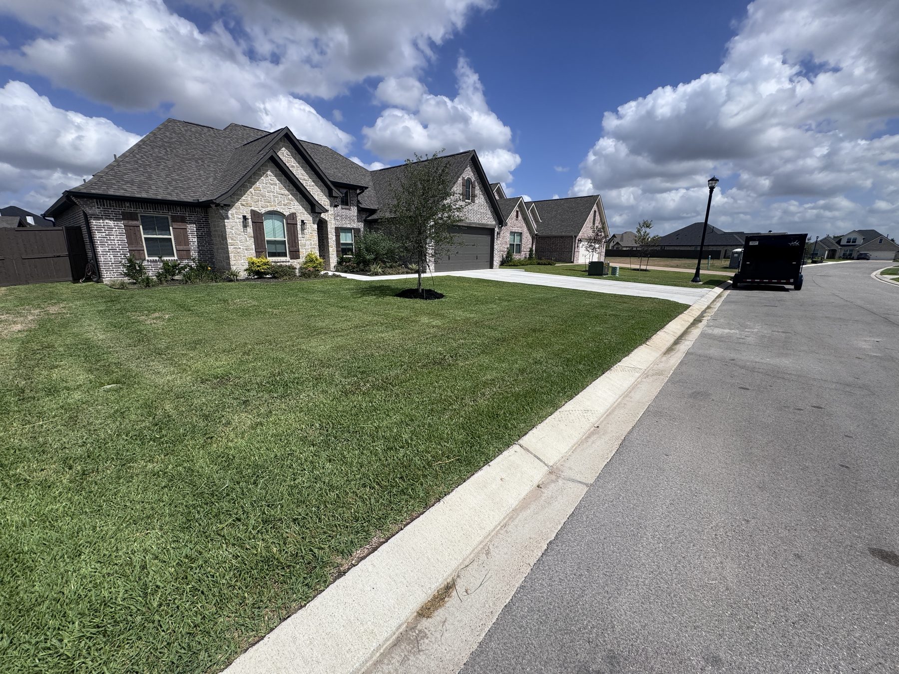 Wide view of a freshly maintained neighborhood lawn